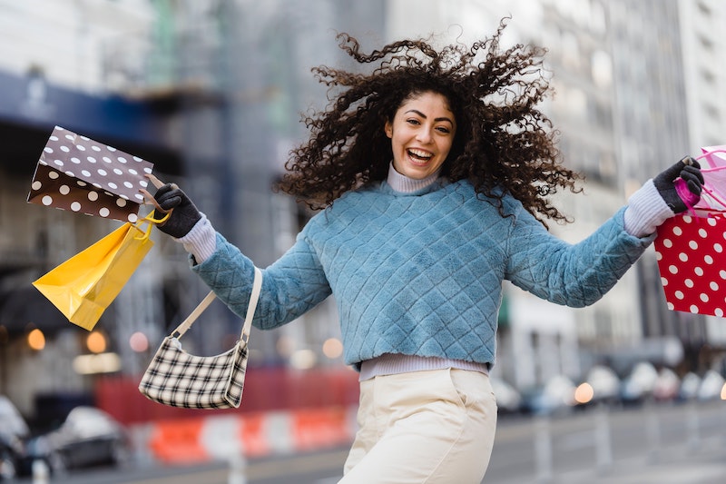 Girl with shopping bags impulsively shopping